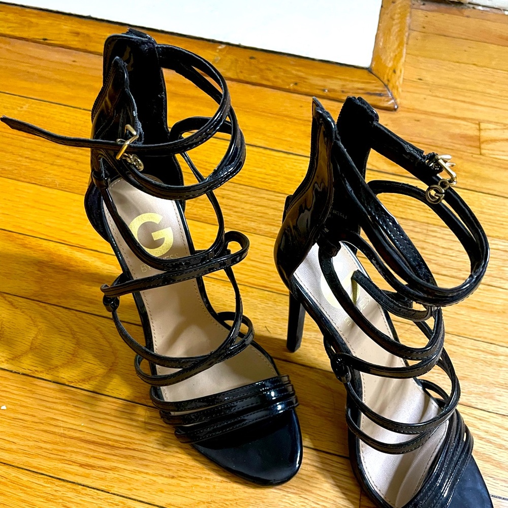 Black strappy stiletto sandals by Guess.